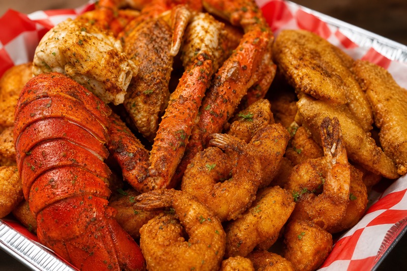 Seafood feast with lobster tail, crab legs, and fried shrimp